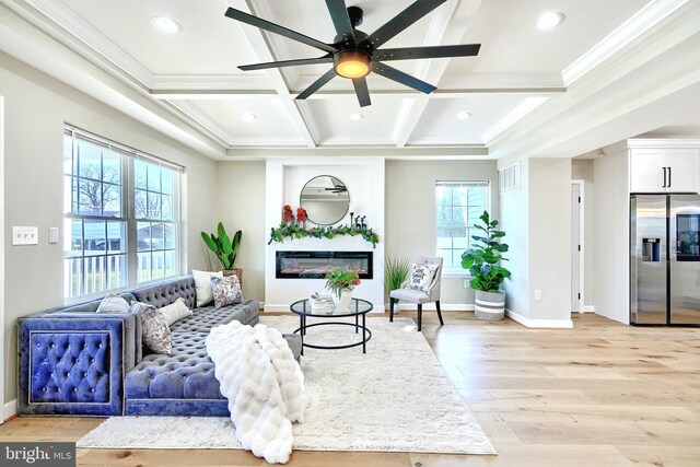 kitchen featuring white cabinetry, sink, pendant lighting, appliances with stainless steel finishes, and ornamental molding