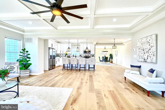 kitchen featuring a center island, white cabinets, pendant lighting, and appliances with stainless steel finishes