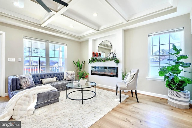 living room with beamed ceiling, coffered ceiling, and light wood-type flooring