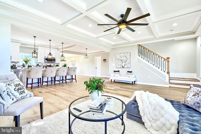 kitchen with a notable chandelier, light stone counters, white cabinetry, and appliances with stainless steel finishes