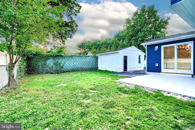 view of yard featuring an outbuilding and a patio