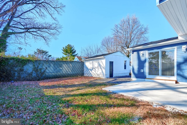 view of yard with a patio and an outbuilding