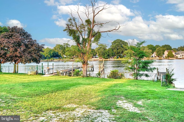 view of yard featuring a water view and a dock