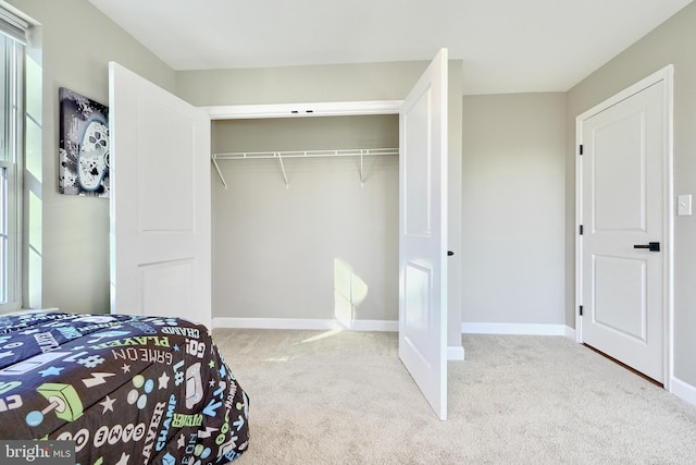 carpeted bedroom with a closet