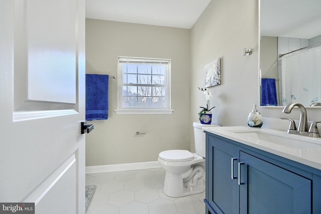 bathroom featuring vanity, tile patterned flooring, and toilet