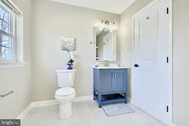 bathroom with vanity, tile patterned flooring, and toilet