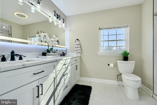 bathroom featuring tile patterned floors, vanity, and toilet