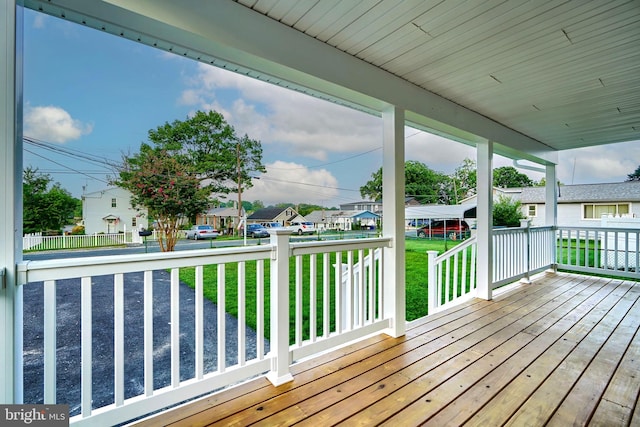 wooden terrace with a yard and a porch