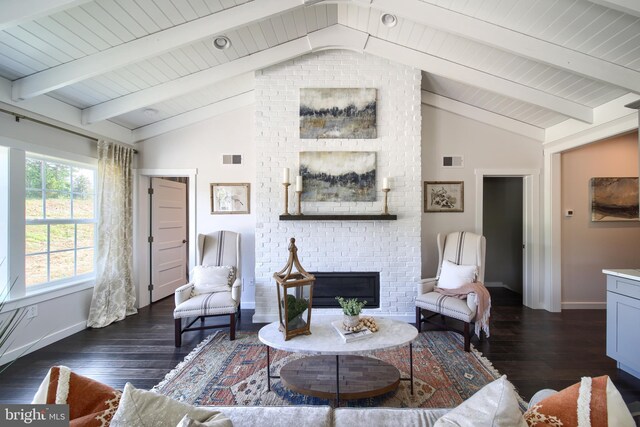 living room featuring dark hardwood / wood-style floors, lofted ceiling with beams, and a brick fireplace