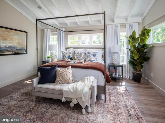 bedroom featuring lofted ceiling with beams and hardwood / wood-style floors