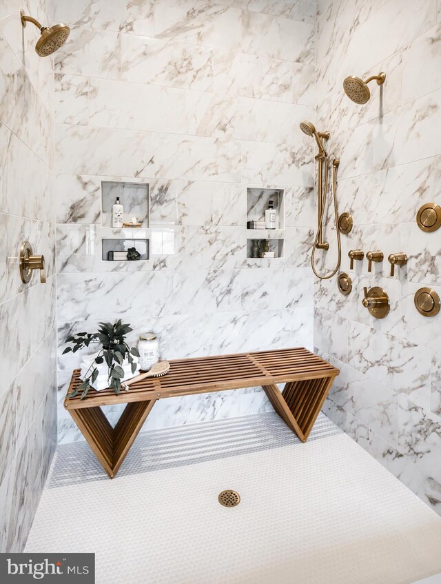 interior details featuring tiled shower