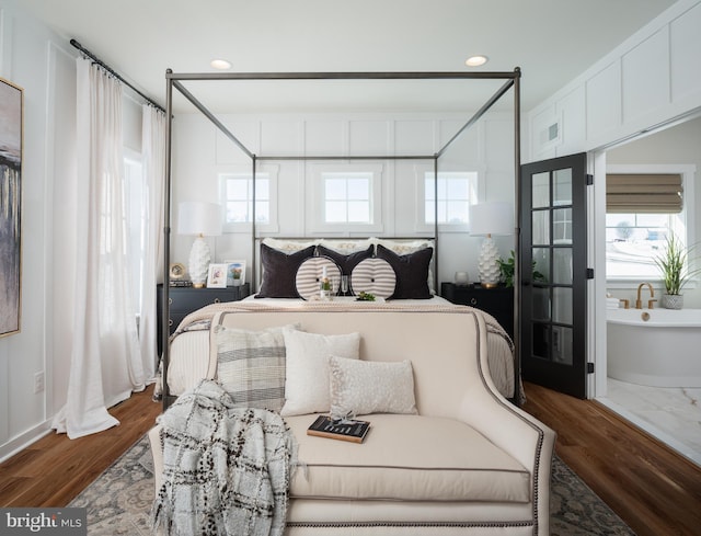 bedroom featuring recessed lighting, dark wood-style flooring, and multiple windows