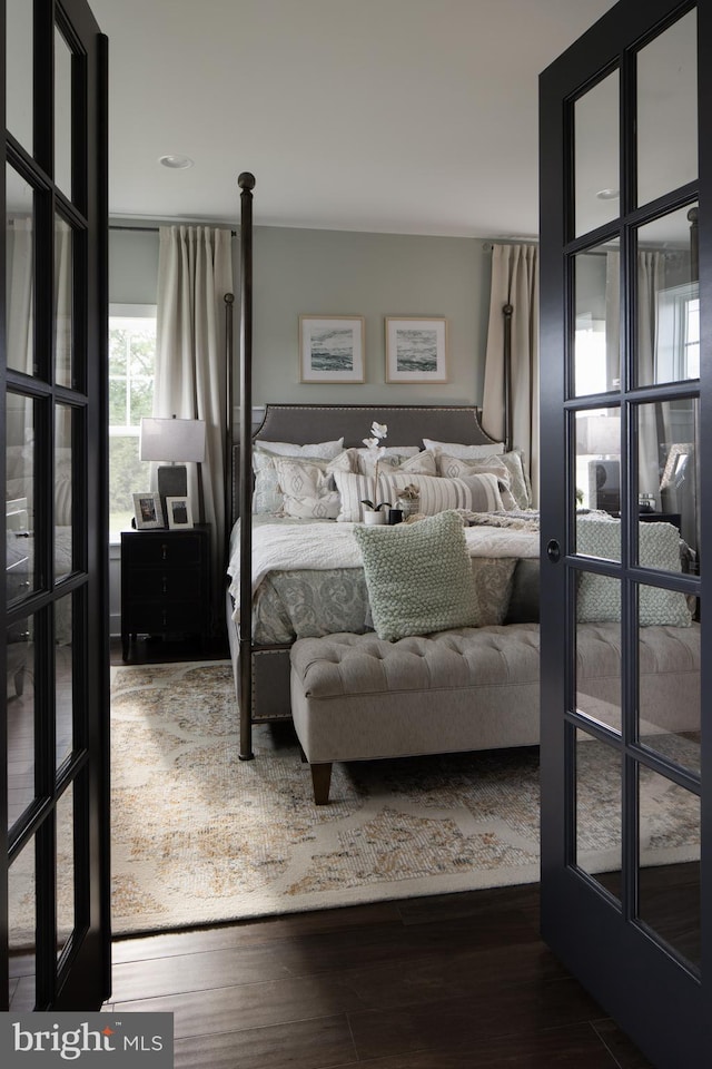 bedroom featuring french doors and wood finished floors