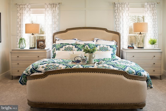 carpeted bedroom featuring a decorative wall