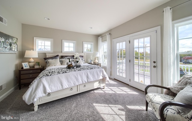 bedroom with access to outside, visible vents, and light colored carpet