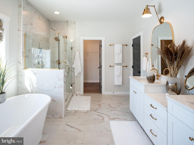 full bath featuring a soaking tub, marble finish floor, vanity, a shower stall, and recessed lighting