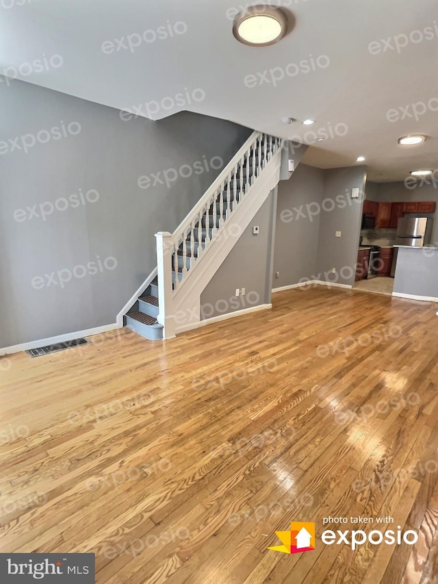 unfurnished living room with wood-type flooring