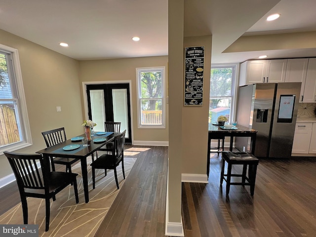 dining area featuring dark wood-type flooring