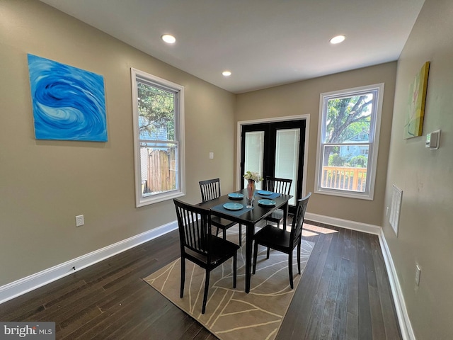 dining space featuring dark hardwood / wood-style floors, french doors, and a wealth of natural light