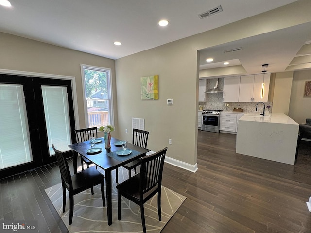 dining area featuring dark hardwood / wood-style floors and sink