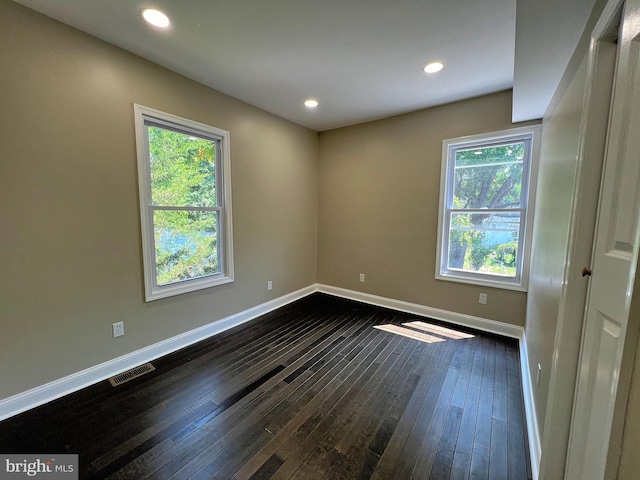 empty room with dark hardwood / wood-style floors