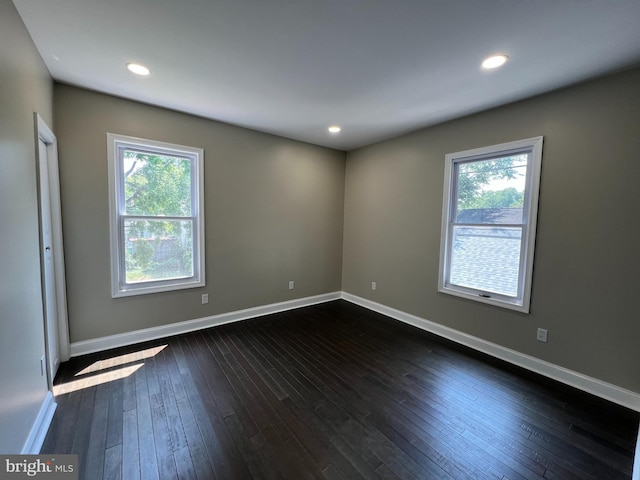 spare room featuring dark wood-type flooring