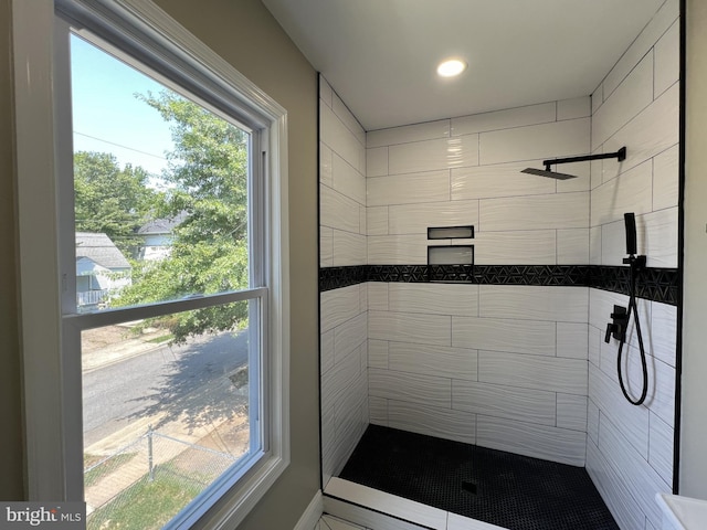 bathroom featuring tiled shower and a healthy amount of sunlight