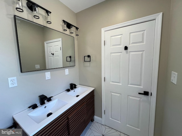 bathroom with dual vanity and tile patterned flooring