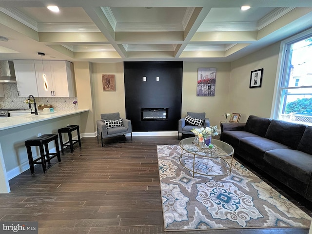 living room with sink, beamed ceiling, dark hardwood / wood-style floors, and coffered ceiling