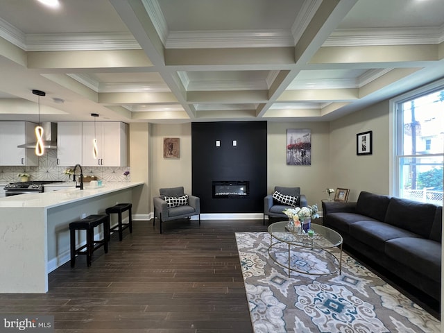 living room featuring crown molding, dark hardwood / wood-style floors, beam ceiling, and coffered ceiling