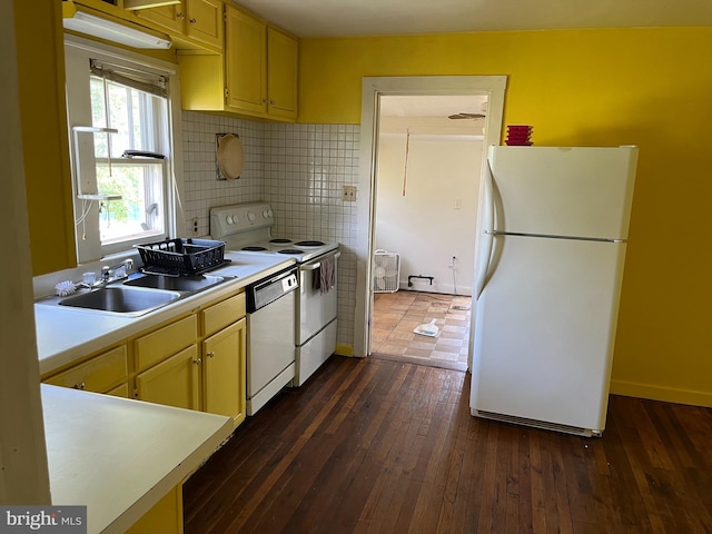 kitchen with sink, white appliances, dark hardwood / wood-style flooring, and tasteful backsplash