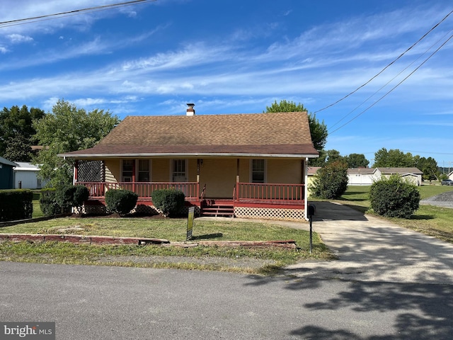 view of front of property with a porch and a front yard