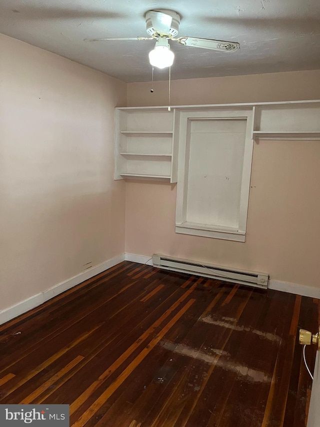 spare room with hardwood / wood-style flooring, baseboard heating, and ceiling fan