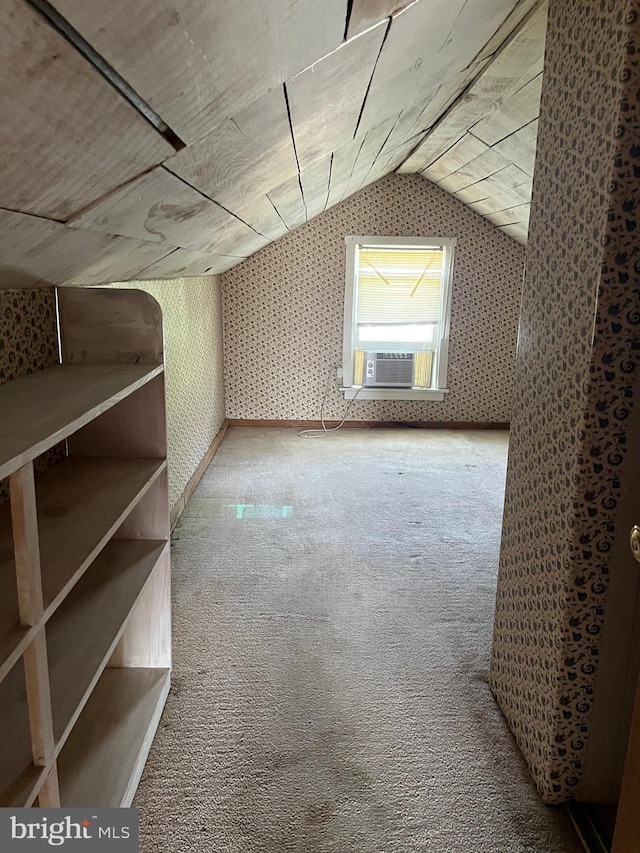 bonus room with lofted ceiling and light carpet