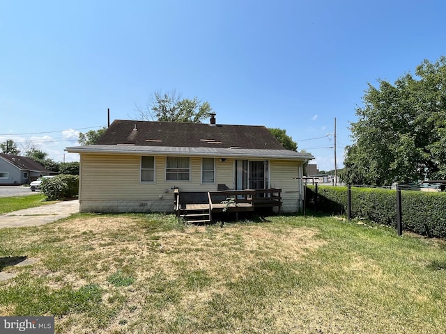 back of house with a yard and a deck