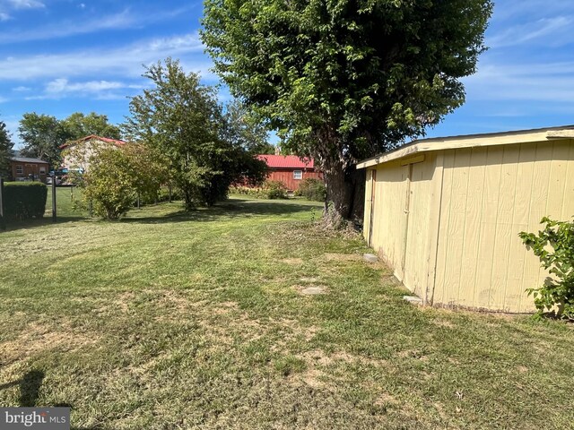 back of property featuring a lawn and a wooden deck