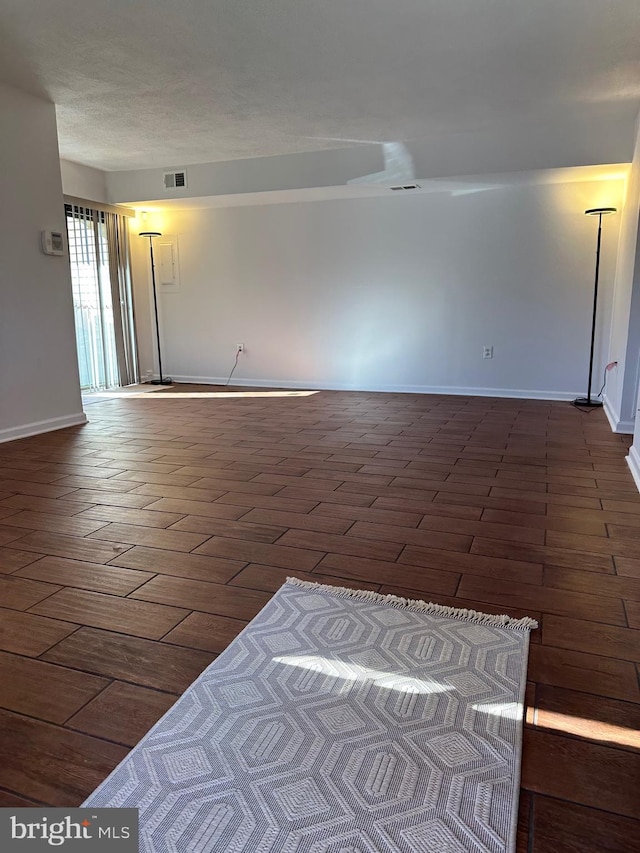 empty room with dark hardwood / wood-style floors