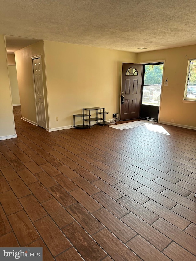 foyer with a textured ceiling