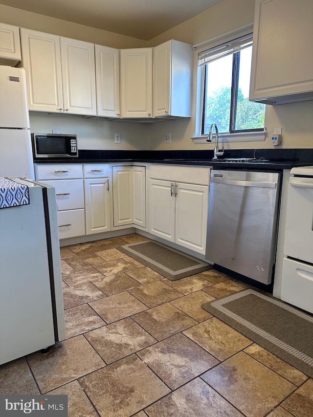 kitchen featuring sink, electric range, white cabinets, stainless steel dishwasher, and white fridge