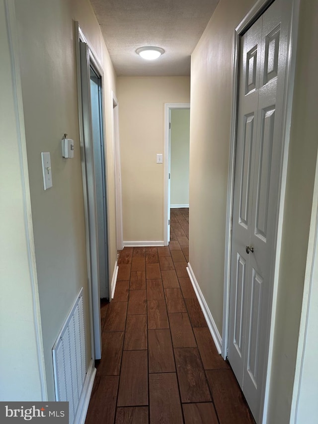 corridor featuring a textured ceiling