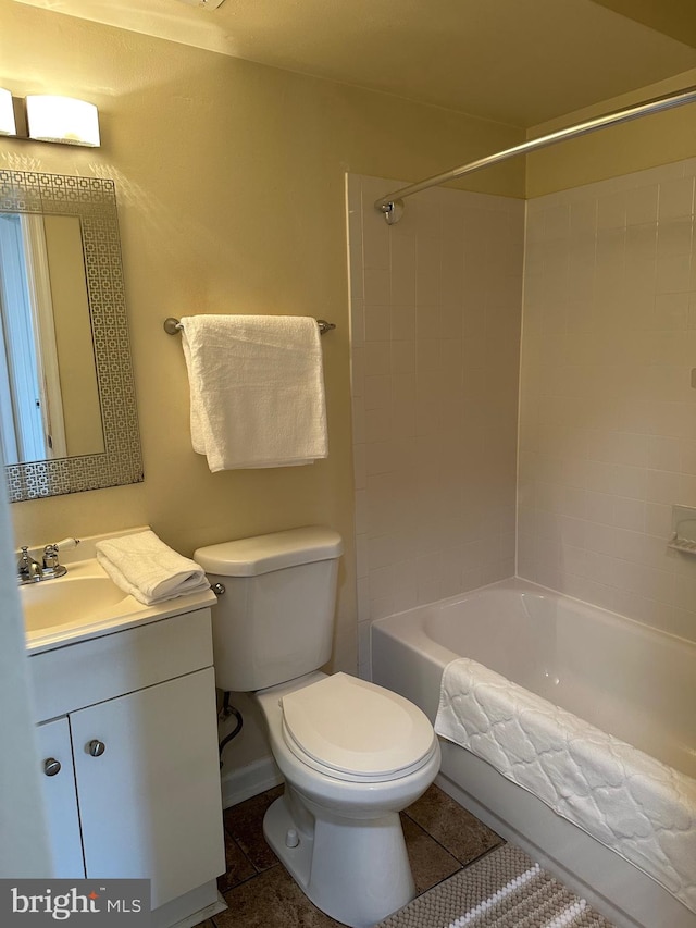 full bathroom with vanity, tiled shower / bath, and toilet