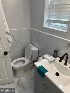 bathroom with vanity, toilet, and tile patterned flooring