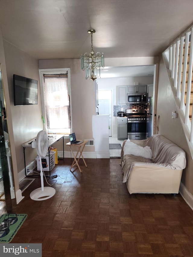 living room featuring parquet floors and a chandelier