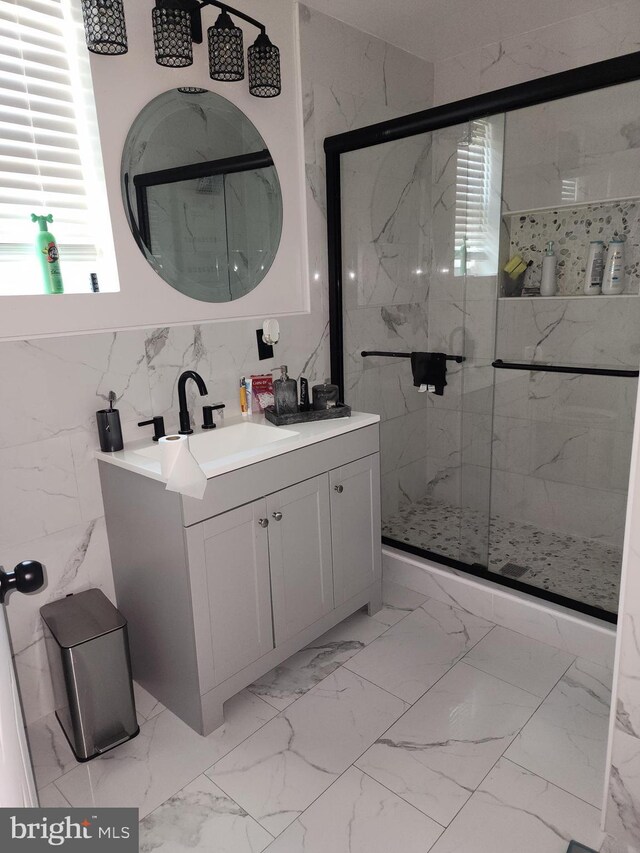 bathroom with vanity, walk in shower, and tile patterned flooring