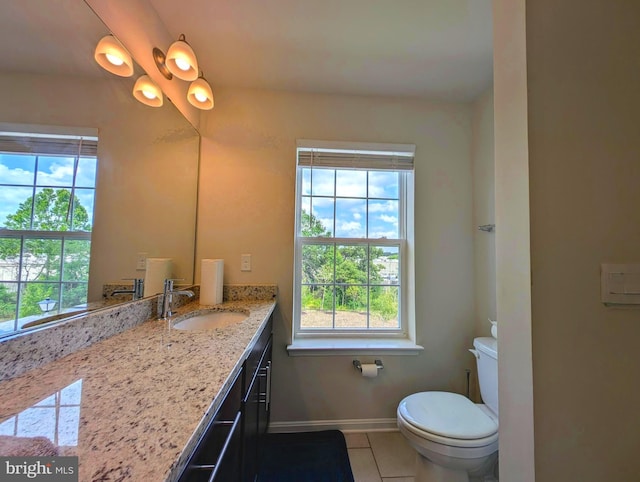 bathroom with vanity, toilet, and tile patterned flooring