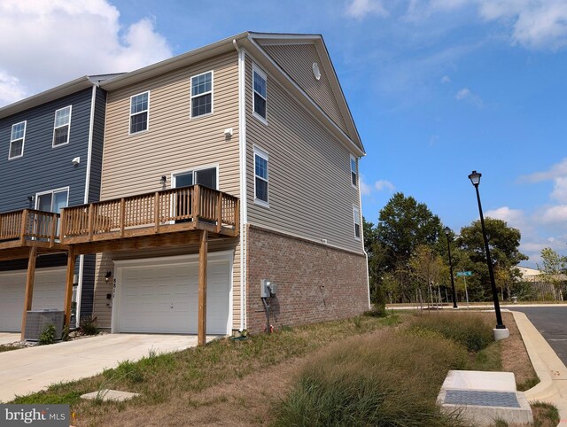 exterior space featuring cooling unit and a garage