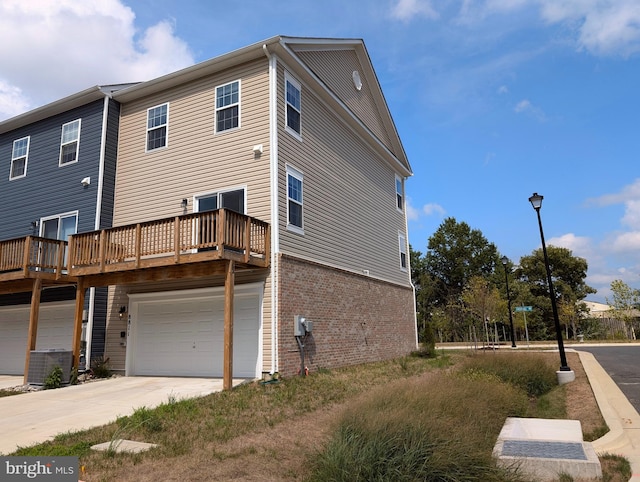 rear view of house with a garage and a deck