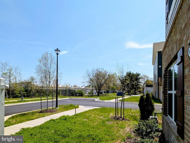 view of road featuring street lighting and sidewalks