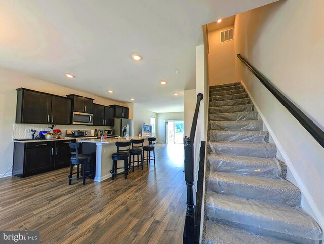 staircase featuring dark hardwood / wood-style flooring and sink