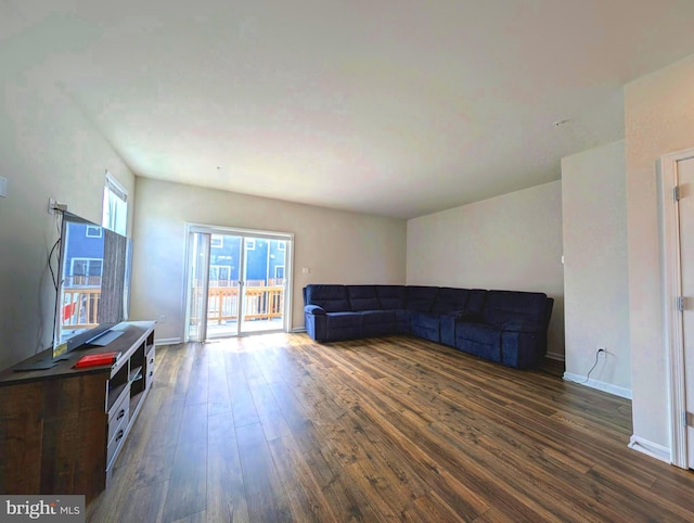 unfurnished living room with dark hardwood / wood-style flooring